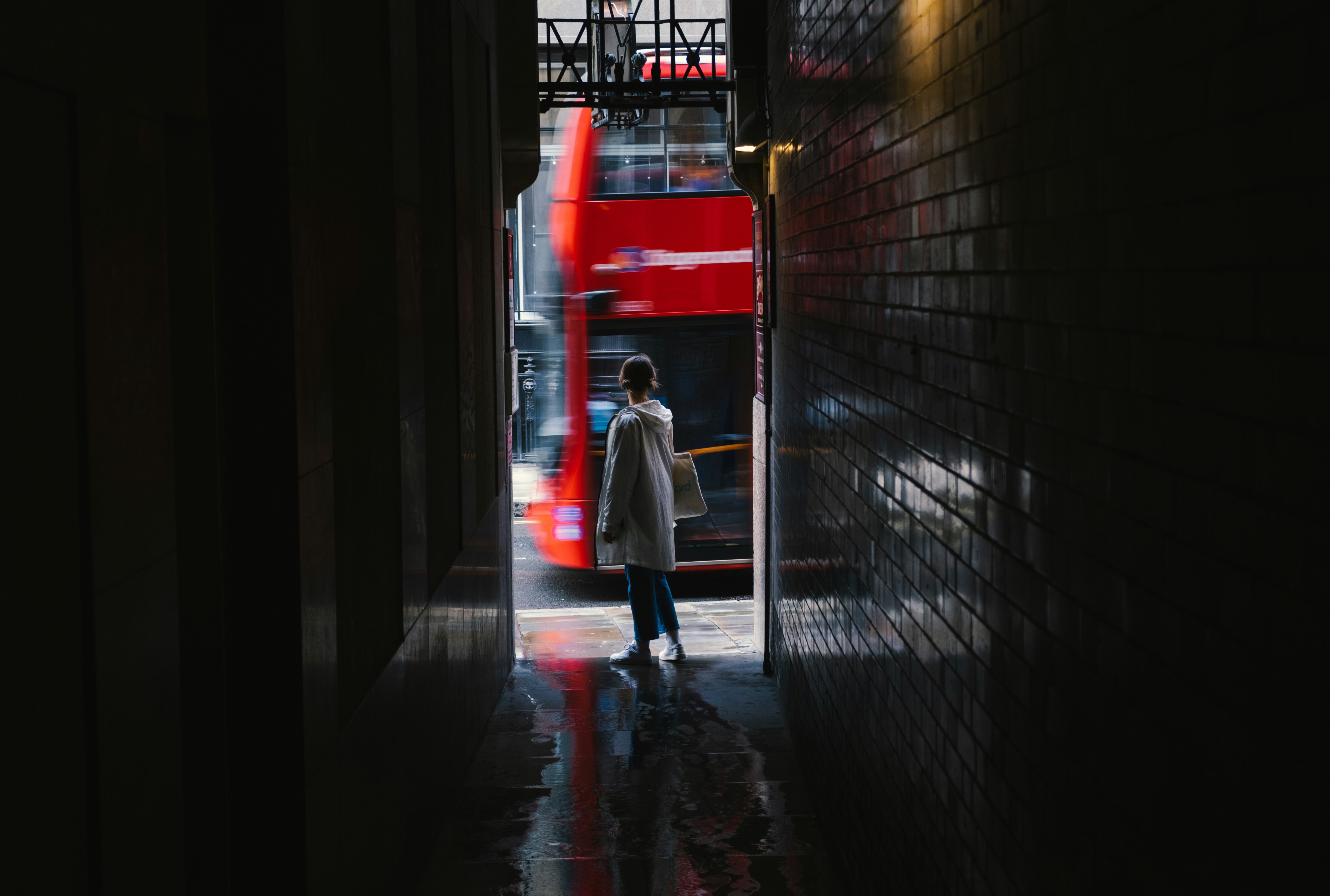 woman in white coat walking on hallway